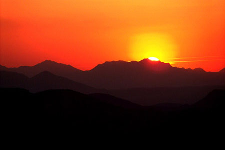 Last glimpse of the sun as it sets behind the mountains